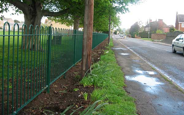 Green fencing around park